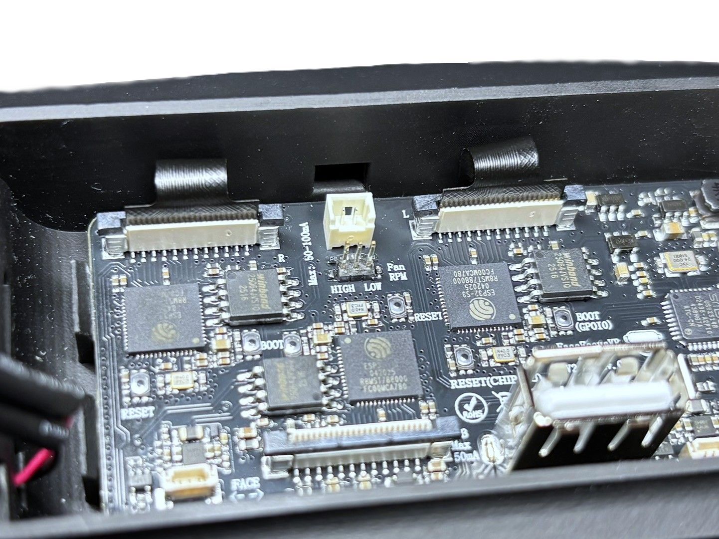 Black connector tabs lifted upward to open the ZIF connector